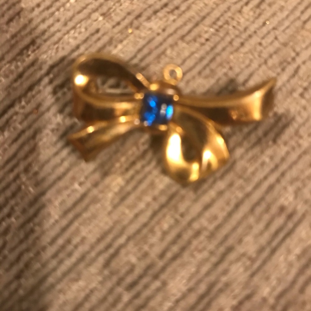Vintage gold colored bow brooch, blue rhinestone